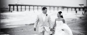 black and white photo of bride and groom on beach