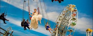 bride and groom on swing ride