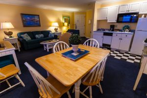 suite open living area and kitchen with checkered floor