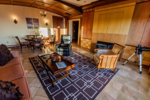 Penthouse living area with carpet and tiled floors