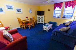 suite living area with blue carpets