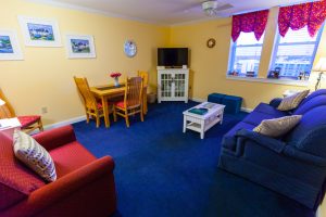 Suite living area with blue carpeting