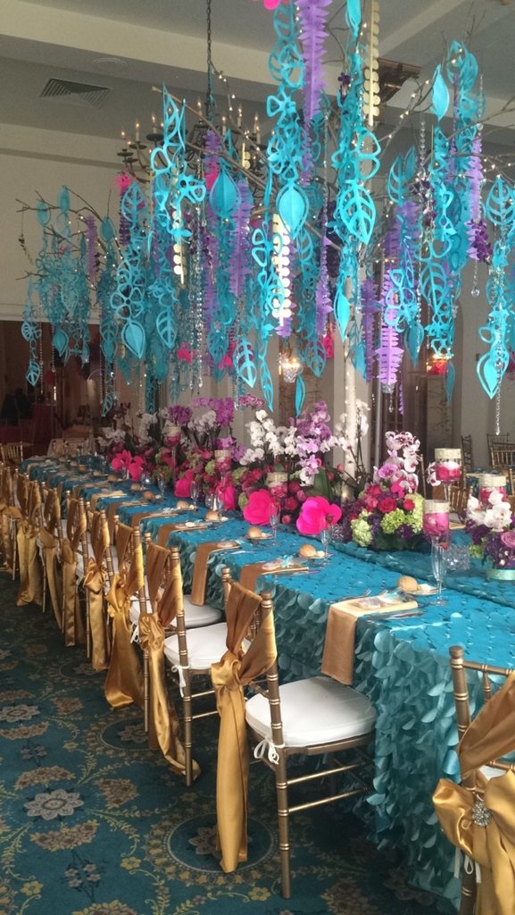 Candlelight ballroom setup; colorful teals and pinks