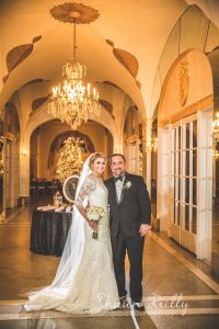 bride and groom posing in the hall of mirrors