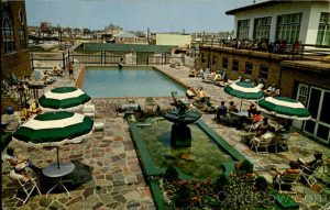 Vintage photo of swimming pool with greenery and tables