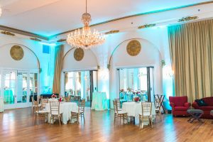 interior crystal ballroom with teal, orange and pink florals