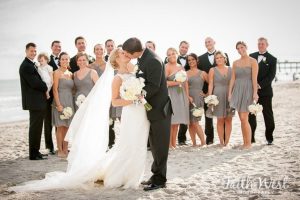 bride and groom kissing on the beach