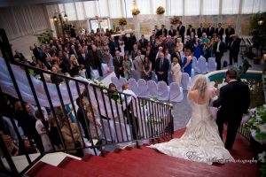 bride and groom descending staircase in garden room