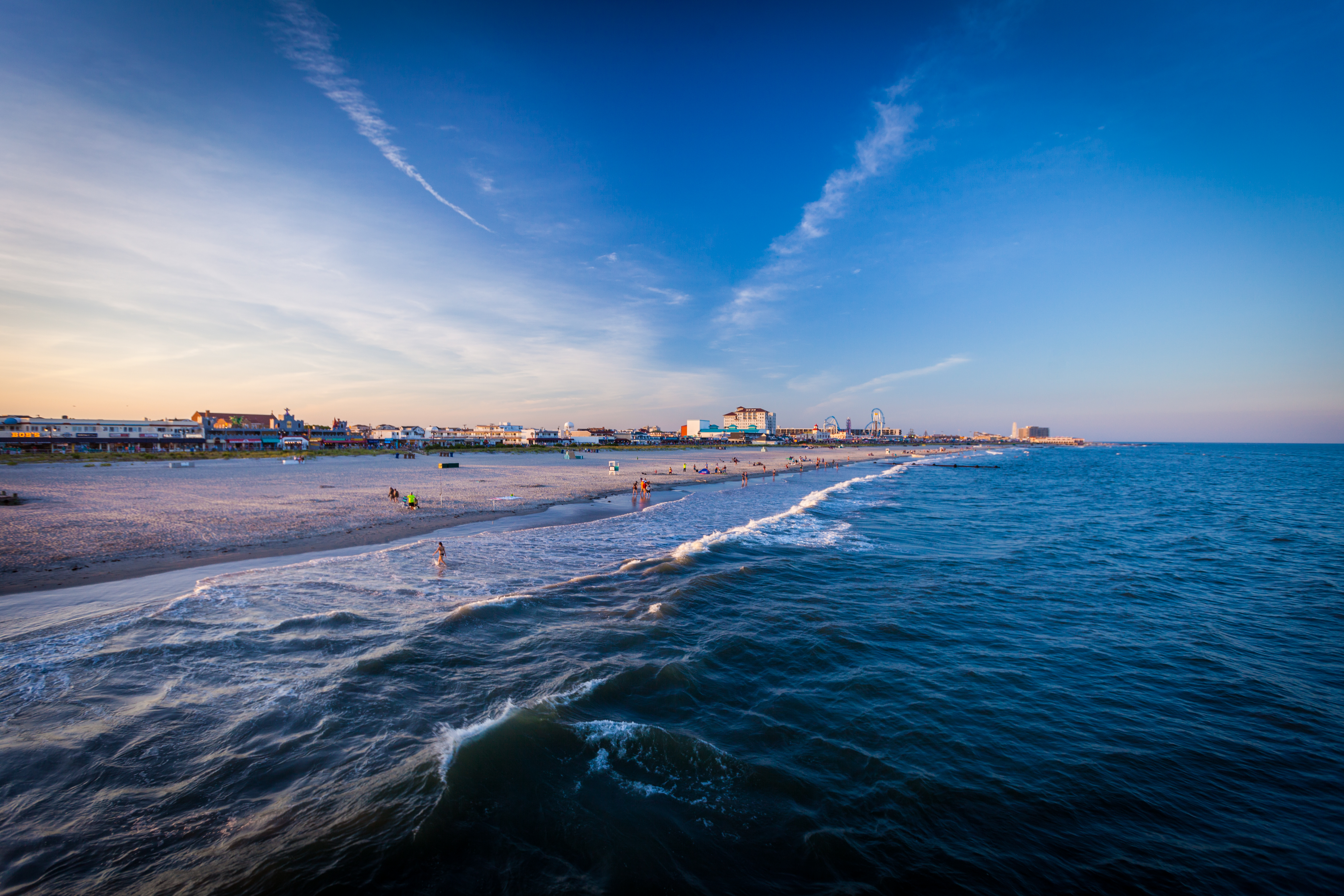 Photo of the ocean with The Flanders Hotel in the far distance