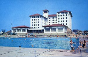 Vintage photo of salt water pool outside of hotel. hotel in background