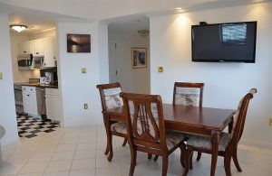 Suite living area and kitchen with checkered floor tiles