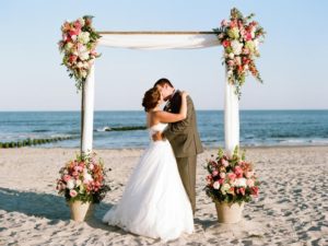 Bridge and Groom kissing on the beach