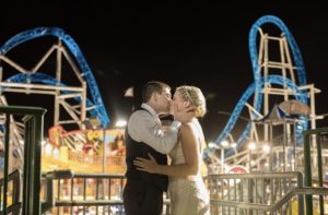 couple kissing on the boardwalk