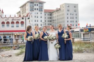 Bridal party on the beach; bridesmaids in blue